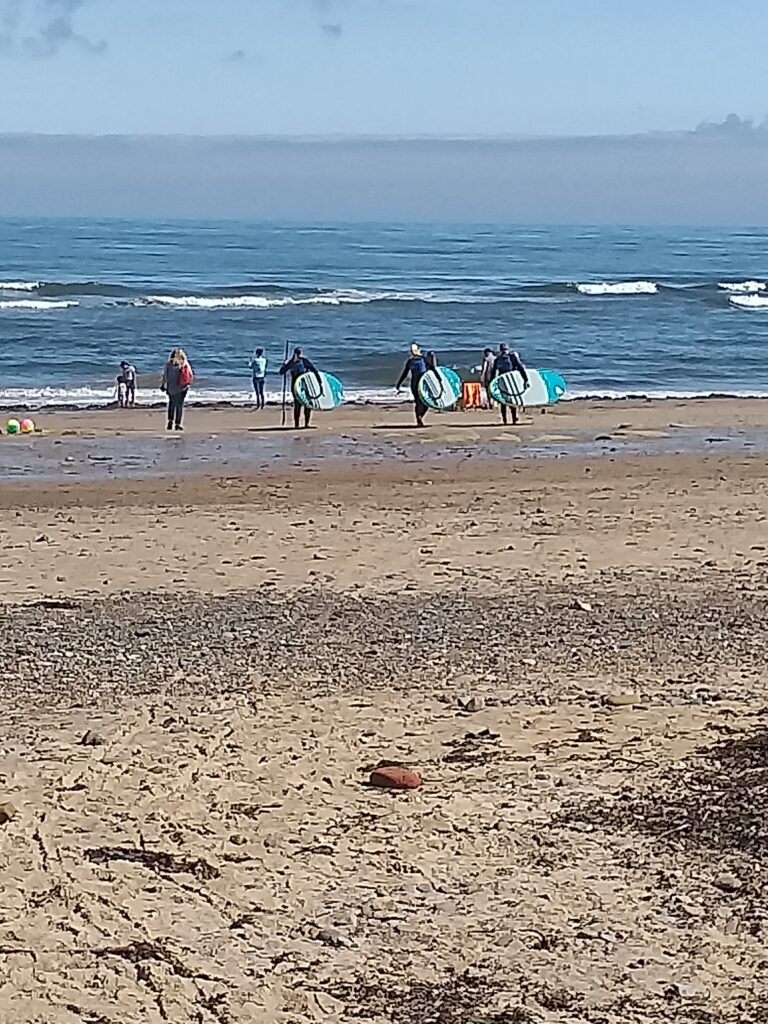 surfers on the shoreline