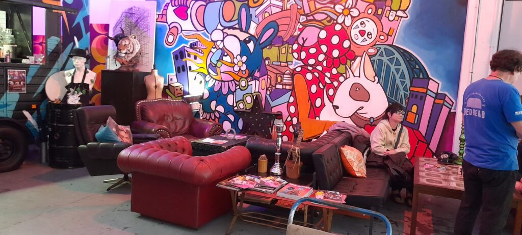 armchairs next to a brightly coloured graffiti mural